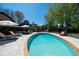 Sparkling pool surrounded by lounge seating and lush greenery, perfect for enjoying sunny days and outdoor entertaining at 2014 Ion Ave, Sullivans Island, SC 29482