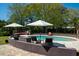 Inviting pool area with lounge chairs, umbrellas, and beautifully landscaped surroundings. Ideal for relaxation and entertaining at 2014 Ion Ave, Sullivans Island, SC 29482