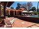 Backyard patio with a pool, lounge chairs, a white rocking chair, and an arched covered porch at 2014 Ion Ave, Sullivans Island, SC 29482