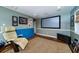 Finished basement media room with a large screen, hardwood floors, and neutral walls at 2014 Ion Ave, Sullivans Island, SC 29482