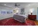 Comfortable bedroom features a ceiling fan, vibrant rug, and plenty of natural light at 2014 Ion Ave, Sullivans Island, SC 29482