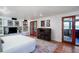 Spacious bedroom featuring a cozy fireplace, built-in shelving, and sliding glass doors at 2014 Ion Ave, Sullivans Island, SC 29482