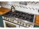 Close up of a commercial range with butcher block countertops and herringbone backsplash at 2014 Ion Ave, Sullivans Island, SC 29482