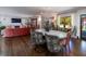 Open-concept dining room with a chandelier and a view to the living area and outdoor pool at 2014 Ion Ave, Sullivans Island, SC 29482