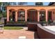 Home exterior showcases an inviting covered patio, outdoor seating, and manicured landscaping at 2014 Ion Ave, Sullivans Island, SC 29482