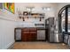 Charming kitchenette features stainless steel appliances, custom cabinets, and vintage lighting accents at 2014 Ion Ave, Sullivans Island, SC 29482