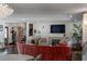 Comfortable living room with a fireplace, staircase, hardwood floors, and large windows for ample natural light at 2014 Ion Ave, Sullivans Island, SC 29482