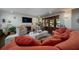 Spacious living room with a coral sofa, stylish coffee table, fireplace, and access to outdoor views at 2014 Ion Ave, Sullivans Island, SC 29482