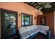 Covered patio area with plush seating, ceiling fan, and views of the pool and lush landscaping at 2014 Ion Ave, Sullivans Island, SC 29482