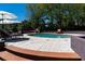 Backyard pool area features a round swimming pool, tiled patio, lounge chairs, and lush greenery at 2014 Ion Ave, Sullivans Island, SC 29482