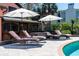 Poolside lounge area featuring comfortable seating and a large umbrella providing ample shade at 2014 Ion Ave, Sullivans Island, SC 29482