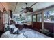 Bright sunroom featuring wood floors, ample windows, comfortable seating, and a unique fireplace at 2014 Ion Ave, Sullivans Island, SC 29482