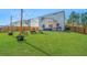 Spacious backyard with lush green lawn and outdoor fire pit area with seating at 204 Torslanda Ln, Summerville, SC 29486
