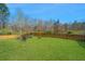 Spacious backyard with lush green lawn and outdoor fire pit area with seating at 204 Torslanda Ln, Summerville, SC 29486