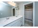 Modern bathroom with double sinks, a quartz countertop, and a view of the shower/tub through an open doorway at 204 Torslanda Ln, Summerville, SC 29486