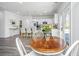 Sunlit dining area with French doors, wood table, views into kitchen, and pendant lighting at 204 Torslanda Ln, Summerville, SC 29486