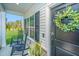 Relaxing front porch with rocking chairs and a decorative wreath on the front door at 204 Torslanda Ln, Summerville, SC 29486