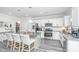 Spacious kitchen island offers seating and granite countertops, accompanied by stainless appliances and white cabinetry at 204 Torslanda Ln, Summerville, SC 29486