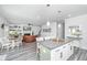 Open-concept eat-in kitchen with an island, granite countertops, pendant lighting, and stainless appliances at 204 Torslanda Ln, Summerville, SC 29486