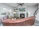 Bright and spacious living room, fireplace, ceiling fan, and a large leather sectional sofa at 204 Torslanda Ln, Summerville, SC 29486