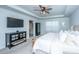 Light-filled main bedroom features a comfortable bed, mounted TV, and neutral decor at 204 Torslanda Ln, Summerville, SC 29486
