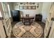 Comfortable office setup with an antique desk, patterned rug, and glass French doors at 204 Torslanda Ln, Summerville, SC 29486