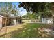 Large backyard with mature trees, a fire pit area, and outbuildings, perfect for outdoor living at 208 James St, Summerville, SC 29483