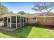 Exterior view of the home and the screened porch with ample yard space at 208 James St, Summerville, SC 29483
