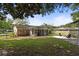 Spacious backyard featuring a screened in porch and stone seating area at 208 James St, Summerville, SC 29483