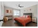 Cozy bedroom featuring hardwood floors, a ceiling fan, and warm, inviting decor at 208 James St, Summerville, SC 29483