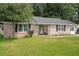 Charming brick home featuring a landscaped front yard and classic architectural details at 208 James St, Summerville, SC 29483