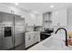 Modern kitchen with stainless steel appliances, white cabinets, and a stylish faucet at 208 James St, Summerville, SC 29483