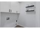 Bright laundry room featuring modern floating shelves and essential utility connections at 208 James St, Summerville, SC 29483