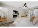 Comfortable main bedroom offers an electric fireplace, mounted TV, and stylish decor at 208 James St, Summerville, SC 29483