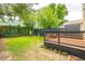 Lush backyard showcasing a new deck, grass lawn, and modern privacy fence at 21 America St, Charleston, SC 29403
