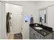 Bathroom featuring a vanity with a dark granite countertop and a walk-in shower at 21 America St, Charleston, SC 29403