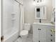 Bathroom featuring a shower-tub combo, toilet, and vanity with marble countertops at 21 America St, Charleston, SC 29403
