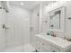 Bright bathroom featuring a walk-in shower with white subway tiles and a modern vanity with a white countertop at 21 America St, Charleston, SC 29403