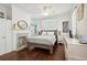 Serene bedroom with hardwood floors, a decorative fireplace, and a comfortable bed with stylish accents at 21 America St, Charleston, SC 29403