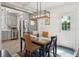 Bright dining area with a glass-topped table, unique lighting, and stainless steel appliances visible at 21 America St, Charleston, SC 29403