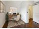 Home office with hardwood floors featuring a wooden desk, chair, and decorative artwork at 21 America St, Charleston, SC 29403
