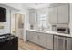 Modern kitchen featuring gray cabinets, white countertops, stainless steel appliances, and subway tile backsplash at 21 America St, Charleston, SC 29403