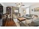Cozy living room with exposed brick fireplace, hardwood floors, and a comfortable gray sofa at 21 America St, Charleston, SC 29403