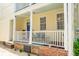 Charming home featuring a white railing porch with outdoor furniture at 21 America St, Charleston, SC 29403