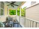 Relaxing porch featuring furniture and a ceiling fan with views of the surrounding foliage at 21 America St, Charleston, SC 29403