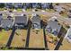 Aerial view of backyard, featuring spacious green lawns with new construction at 211 Saxony Loop, Summerville, SC 29486
