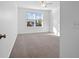 Sunlit bedroom with neutral carpet, and large window offering a view of the outdoors at 211 Saxony Loop, Summerville, SC 29486