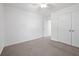 Bright bedroom features neutral carpet, ceiling fan, and double-door closet at 211 Saxony Loop, Summerville, SC 29486