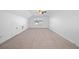 Spacious bonus room with neutral carpet, ceiling fan and large window at 211 Saxony Loop, Summerville, SC 29486