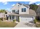 Charming two-story home showcasing a well-manicured lawn and attached two-car garage at 211 Saxony Loop, Summerville, SC 29486